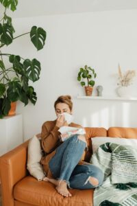 woman with seasonal allergies sneezing