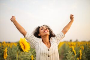 Woman Smiling with Sunflowers